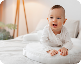 Cute baby laying on a bed